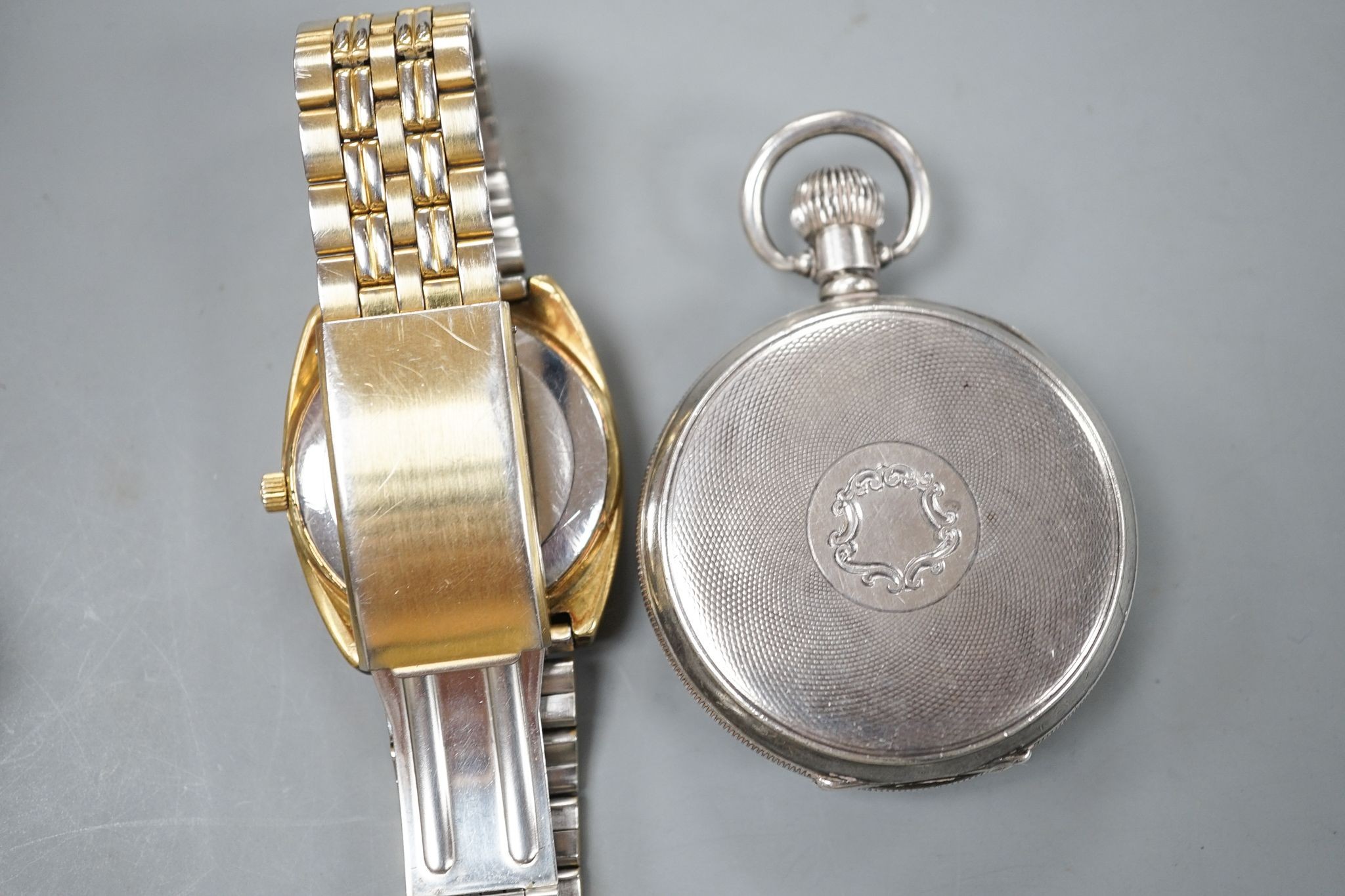 A George V silver Omega open face keyless pocket watch and a gold plated Omega Seamaster day/date automatic wrist watch.